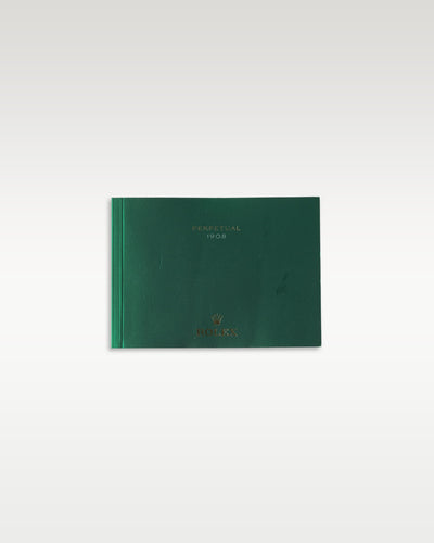 The clean horizontal front profile of the official dark green user operating manual book published for the elegant Rolex 1908 collection