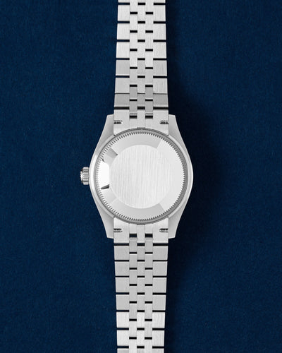 The solid Oystersteel caseback and D-shaped link Jubilee bracelet profile of a Rolex Datejust 31 watch