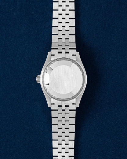 The solid Oystersteel caseback and D-shaped link Jubilee bracelet profile of a Rolex Datejust 31 watch