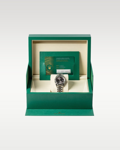 An open iconic green Rolex luxury watch presentation box displaying the brand new Datejust 31 278274 watch inside