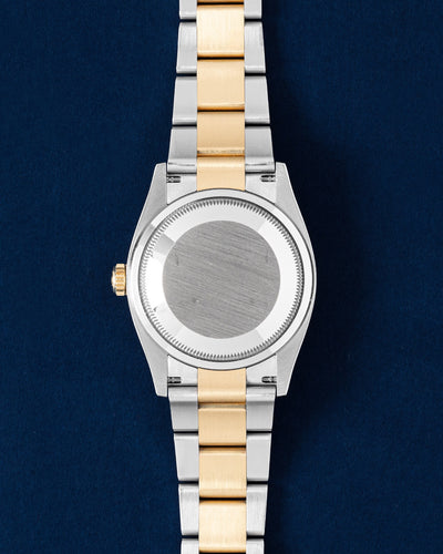 Rear view of the 36mm Rolex Datejust case showcasing the brushed steel solid caseback and the yellow gold and stainless steel three-link Oyster bracelet links