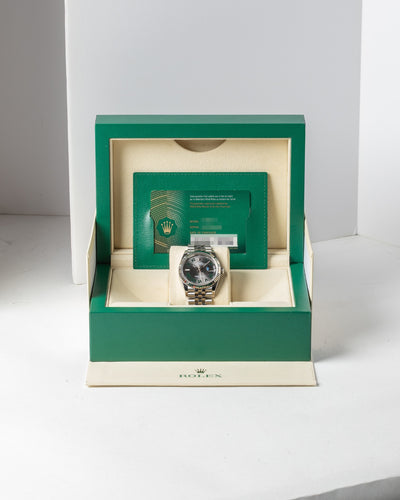 steel 36mm Rolex Datejust Wimbledon watch displayed upright inside its open iconic green presentation box alongside its warranty card holder