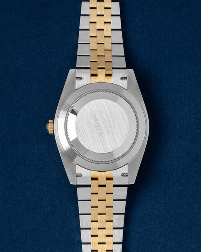 The reverse orientation of the 41mm luxury sports watch head displaying the solid brushed steel Oyster caseback and polished 18k yellow gold winding crown