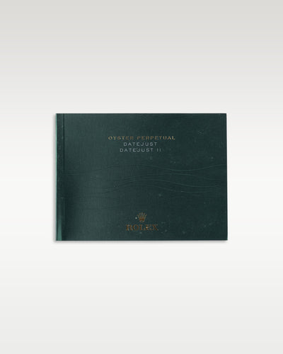The horizontal front cover profile of the traditional dark green user manual booklet supplied globally for the Rolex Datejust family