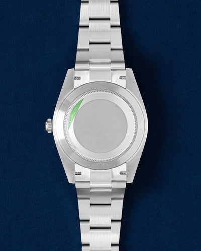 The reverse orientation of the stainless steel watch head highlighting the solid screw down caseback with a green factory sticker for the Rolex Datejust 41 126334 at Grand Caliber in Dallas, Texas