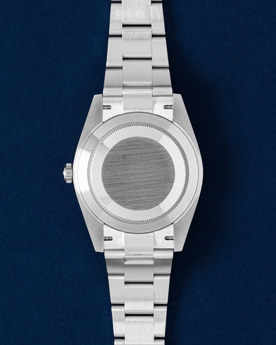 studio view of the 41mm stainless steel Rolex Datejust case showing the brushed solid caseback and three-link Oyster bracelet links