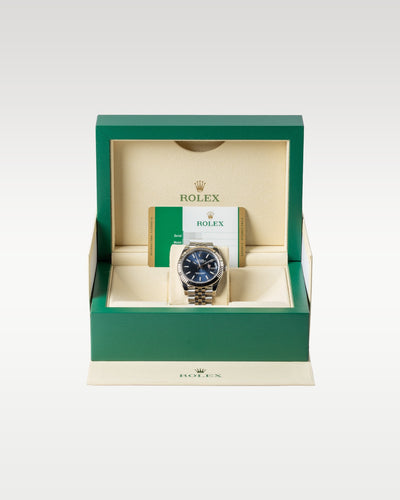 An open iconic green Rolex luxury watch presentation box displaying the Datejust 41 126334 watch safely nested inside