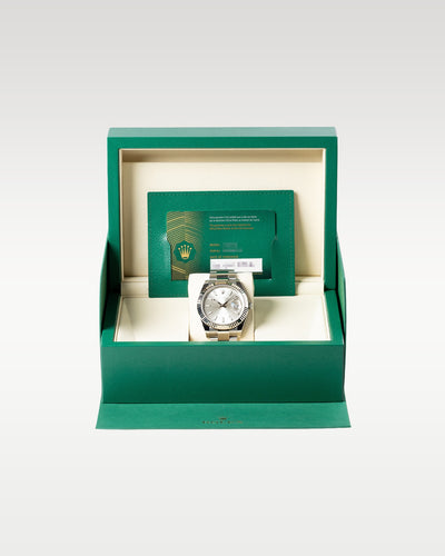 The complete retail collector presentation layout showing the Rolex Datejust 41 126334 timepiece resting safely inside its inner green luxury display box with the guarantee card at Grand Caliber in Dallas, Texas