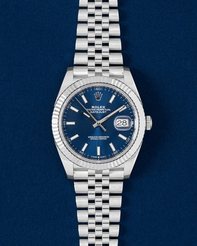 2020 Rolex Datejust 41 126334 watch featuring a royal blue sunray dial, 18k white gold fluted bezel and Jubilee bracelet on a dark blue background