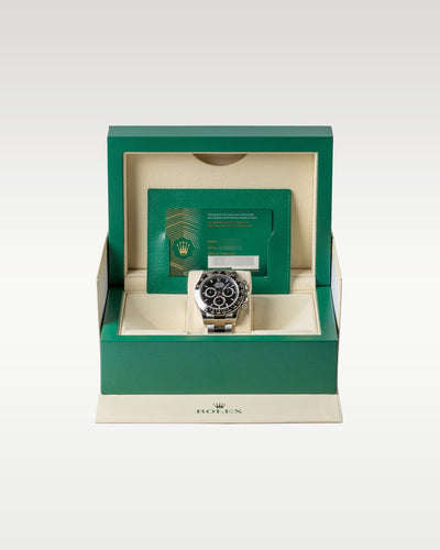 An open iconic green Rolex luxury watch presentation box displaying the 2024 black dial Cosmograph Daytona 126500LN watch inside