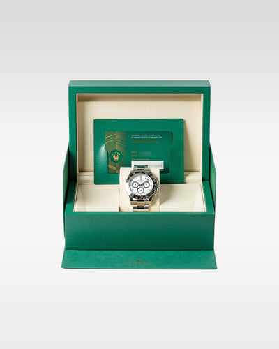 An open iconic green Rolex luxury watch presentation box displaying the brand new 2026 white dial Cosmograph Daytona 126500LN watch inside