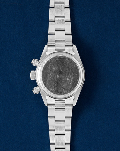 The solid stainless steel caseback profile view of a vintage 1970s manual-wind Rolex Daytona 6265 displaying its brushed finish Oyster bracelet