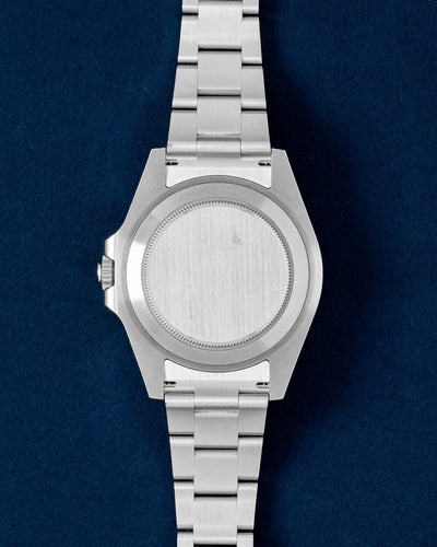 Solid screw-down brushed stainless steel oyster caseback view of a pre-owned Rolex Explorer II sports watch