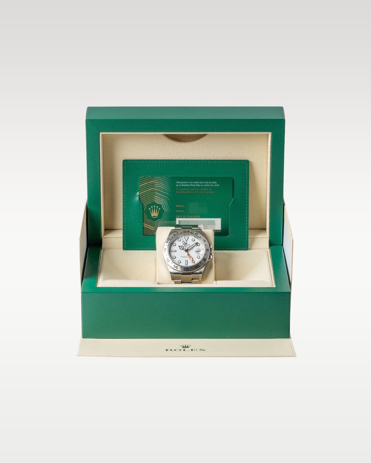 open classic green wave-motif Rolex watch presentation box displaying a full set with a white Polar Explorer II watch inside