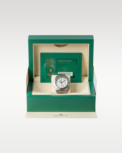 open classic green wave-motif Rolex watch presentation box displaying a full set with a white Polar Explorer II watch inside