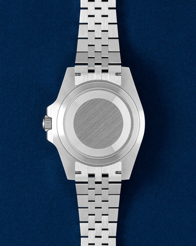 40mm steel Rolex GMT case showing the solid brushed caseback and five-link Jubilee stainless steel bracelet links