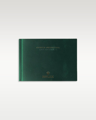 The clean horizontal front cover profile of the dark green user operating manual book specifically published for the GMT-Master II collection