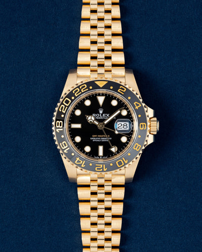 Pre-owned 2024 Rolex GMT-Master II 126718GRNR in 18k yellow gold with black and grey ceramic bezel on Jubilee bracelet at Grand Caliber Dallas