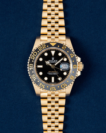 Pre-owned 2024 Rolex GMT-Master II 126718GRNR in 18k yellow gold with black and grey ceramic bezel on Jubilee bracelet at Grand Caliber Dallas
