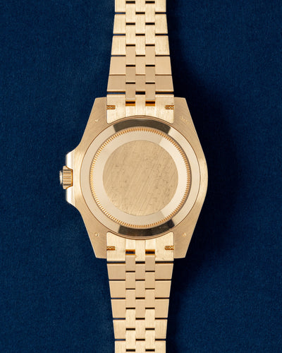 Solid 18k yellow gold screw-down Oyster caseback view of a pre-owned Rolex GMT-Master II luxury watch