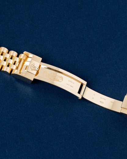 Detailed view of the open folding deployment buckle showing the 5mm Easylink comfort extension system on a gold Rolex GMT bracelet