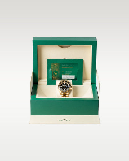 Pre owned 2024 Rolex GMT-Master II 126718GRNR 18k yellow gold complete full set with original green luxury presentation watch box