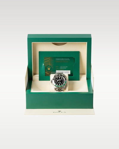open green Rolex luxury watch presentation box displaying the left-handed green and black GMT-Master II 126720VTNR watch inside