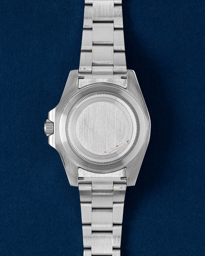 The reverse orientation of the 40mm stainless steel watch head highlighting its flat-brushed solid Oyster screw-down caseback and robust case shoulders