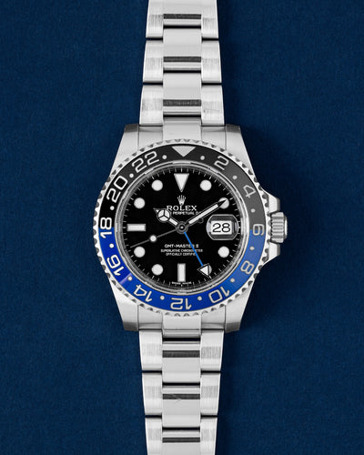 A preowned 2014 Rolex GMT-Master II reference 116710BLNR displaying its original black dial, blue GMT hand, and signature blue and black Cerachrom Batman bezel at Grand Caliber in Dallas