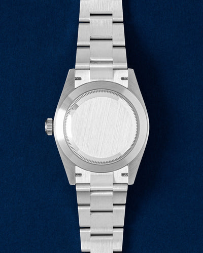 The reverse orientation of the stainless steel watch head highlighting the solid screw down caseback for the Rolex Oyster Perpetual 134300 at Grand Caliber in Dallas, Texas