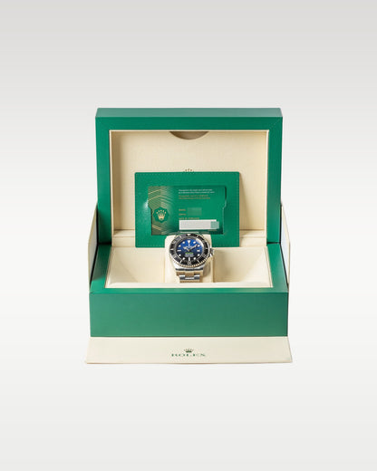 open classic green wave-motif Rolex box displaying a full set with a gradient blue dial James Cameron Deepsea watch inside