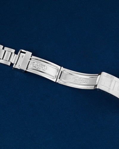 Close up flat lay shot of the interior folding blades of the open stainless steel deployment mechanism showcasing the historical registered factory stamping text for the Rolex Sea Dweller 1665 at Grand Caliber in Dallas, Texas