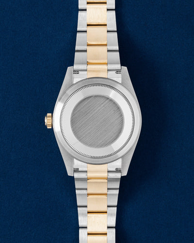 The solid Oystersteel caseback and polished yellow gold center link Oyster bracelet profile of a two-tone Rolex Sky-Dweller watch