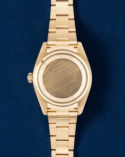 18k yellow gold screw-down caseback on a 42mm Rolex Sky-Dweller luxury travel watch