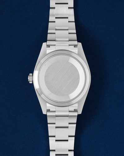 Rear studio view of the 42mm White Rolesor Rolex Sky-Dweller case showing the solid brushed caseback and three-link Oyster bracelet links