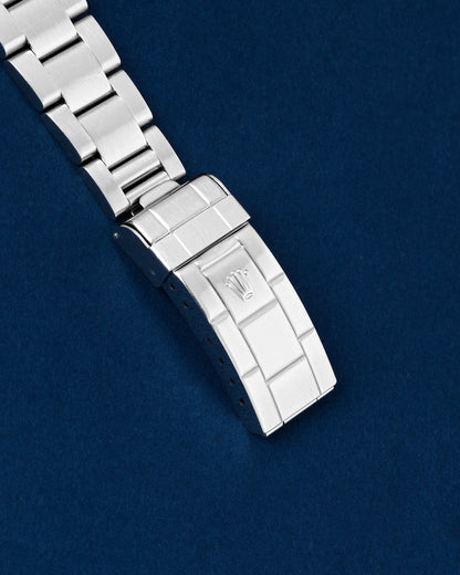 Close-up view of the closed classic stamped stainless steel Oyster clasp on a Rolex Submariner 14060M