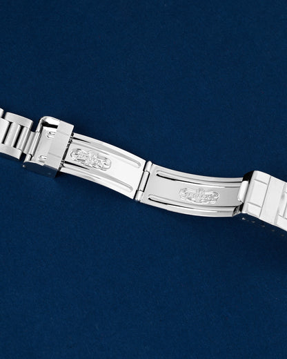 Detailed view of the open folding deployment clasp and dive extension system on a steel Rolex Submariner bracelet