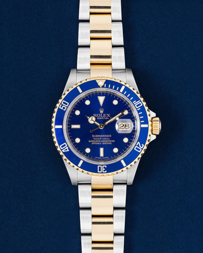 Pre owned 2009 Rolex Submariner Date 16613 Bluesy two-tone yellow gold and steel watch with blue dial at Grand Caliber Dallas