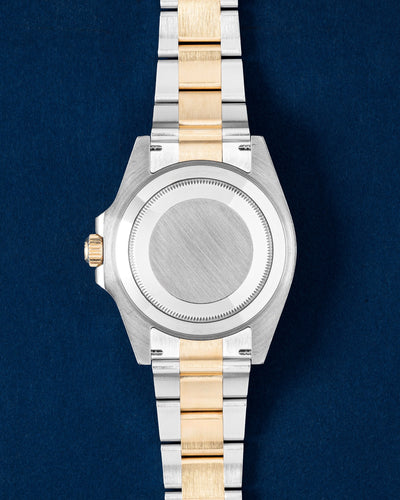 solid stainless steel screw-down caseback on a 41mm two-tone yellow Rolesor Rolex Submariner dive watch