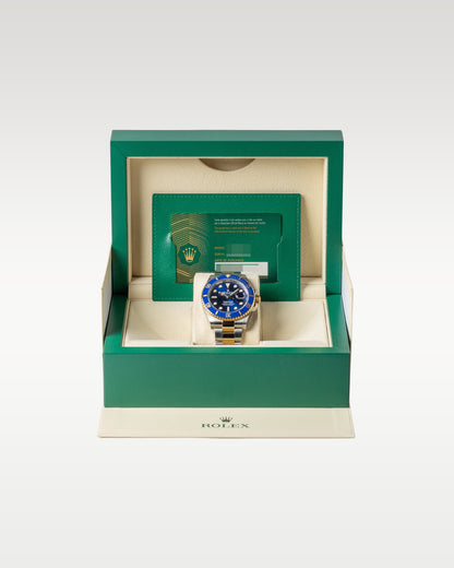 open classic green wave-motif Rolex presentation box displaying a full set with a two-tone Bluesy Submariner watch inside