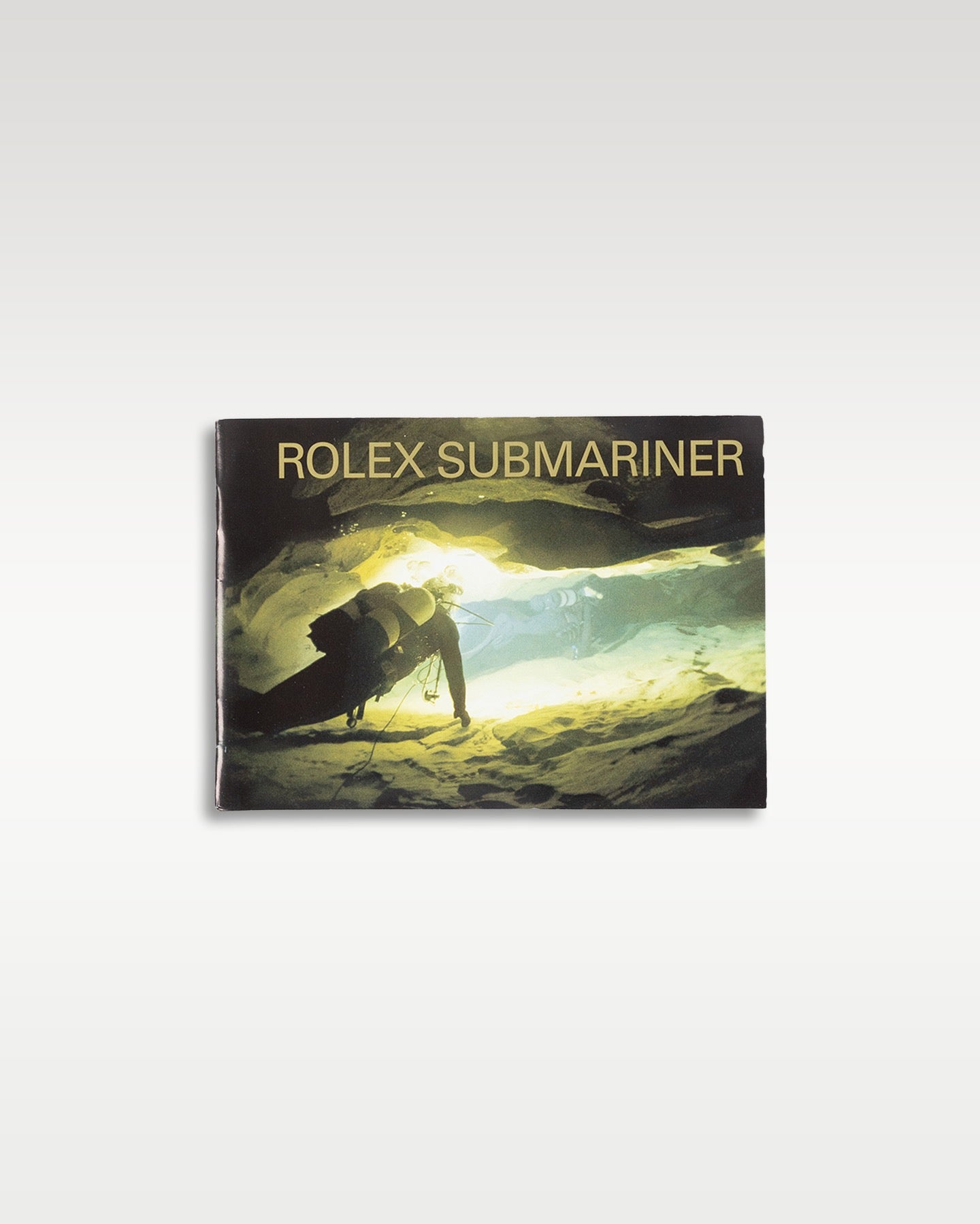 highly collectible vintage Rolex Submariner specific model booklet featuring a deep-sea diver graphic on its front cover