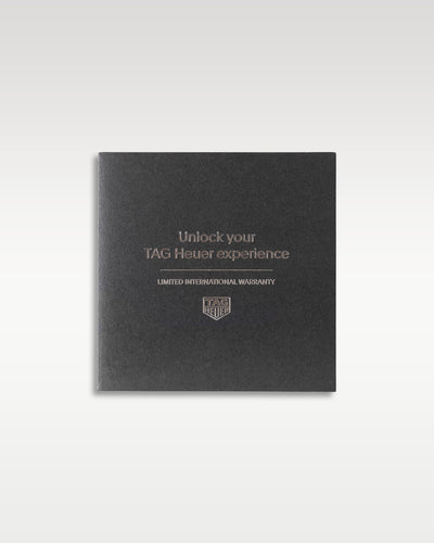 dark grey textured TAG Heuer customer experience welcome guide and ownership booklet resting flat in a studio presentation