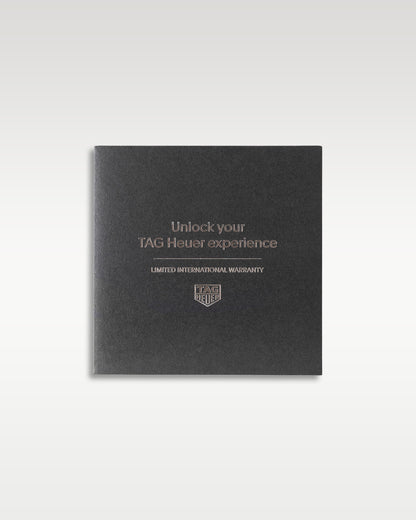 dark grey textured TAG Heuer customer experience welcome guide and ownership booklet resting flat in a studio presentation