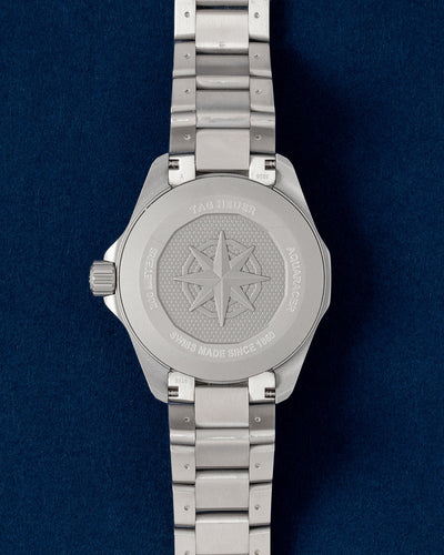 Solid screw-down titanium caseback featuring the engraved compass star motif on a TAG Heuer Aquaracer Solargraph