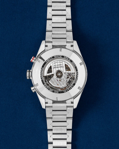 Sapphire crystal exhibition caseback displaying the automatic Calibre 16 chronograph movement on a steel TAG Heuer Carrera