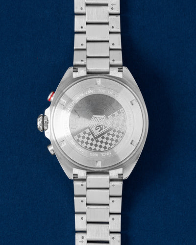 Solid screw-down stainless steel caseback engraved with the signature racing checkered flag motif on a TAG Heuer Formula 1 Chronograph