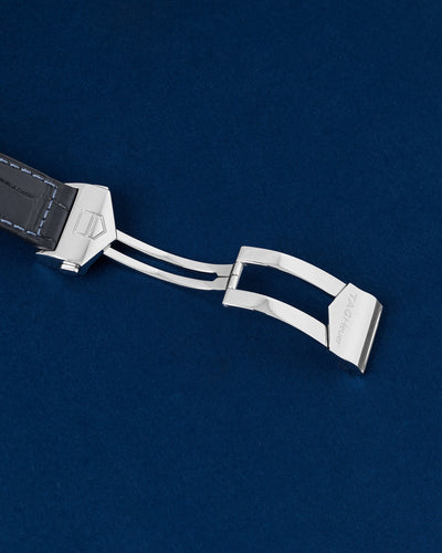 Detailed view of the open push-button deployment folding clasp mechanism on a TAG Heuer Monaco watch strap