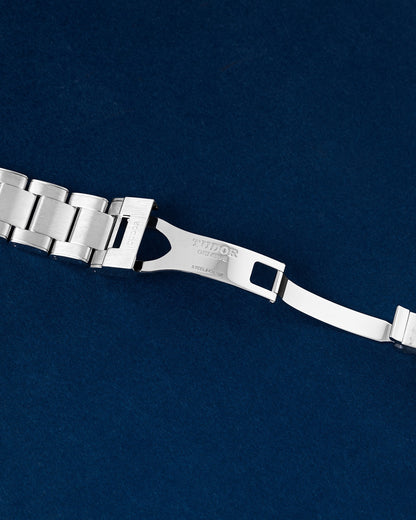 open stainless steel deployment safety clasp mechanism on a Tudor Black Bay 41 watch link bracelet
