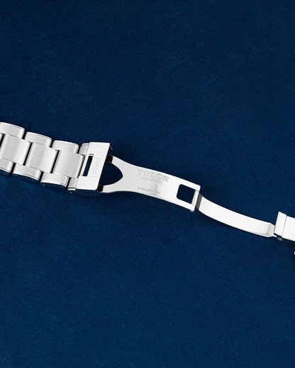 open stainless steel deployment clasp mechanism on a Tudor Black Bay bracelet