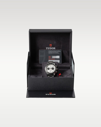 open black textured Tudor luxury watch presentation box displaying a steel Black Bay Chrono Panda watch inside